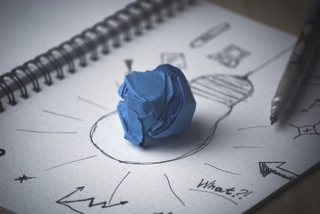 drawing of lightbulb with crumpled blue paper on it  