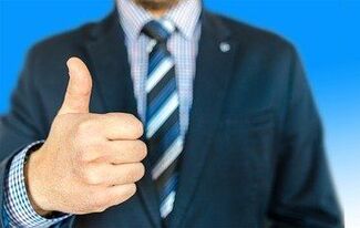 man in suit with thumbs up