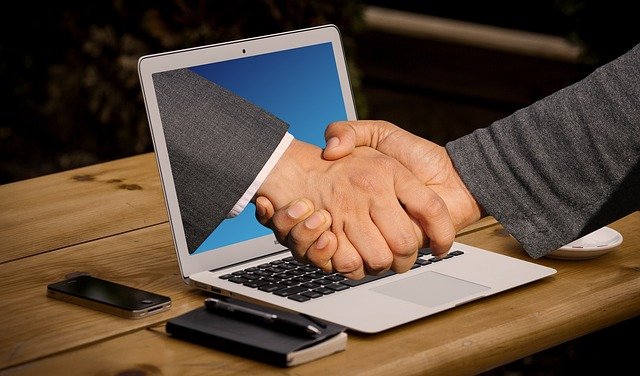handshake and laptop